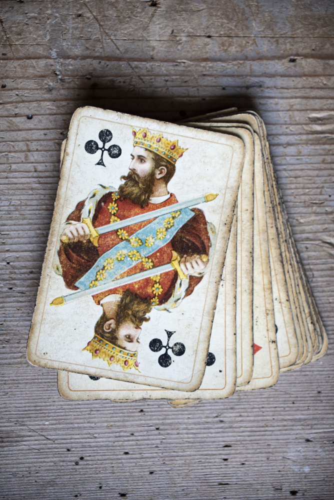 Closeup shot of old playing cards on a wooden table